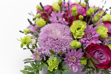 Perfect flower arrangement (Rose, Chrysanthemum, Eustoma, Lavender) in red and lilac colors on a light background