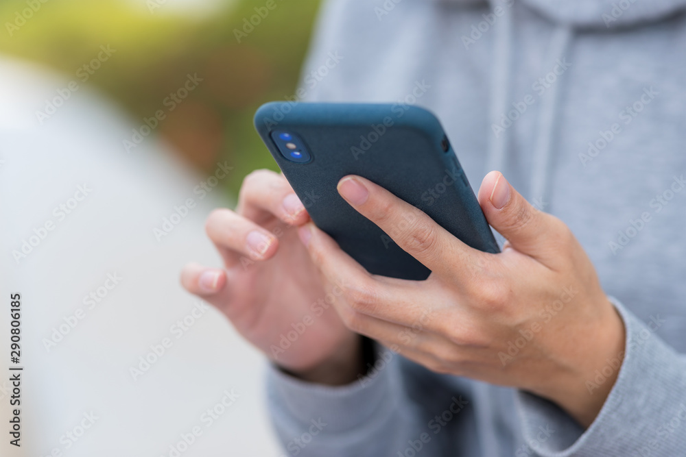 Wall mural Woman use of mobile phone at outdoor