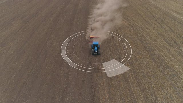 Aerial of autopilot tractor cultivating arable land for seeding