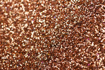 Sparkling copper glitter texture abstract background with bokeh
