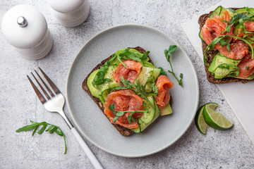 toast with dark rye bread, avocado, smoked salmon and cucumber