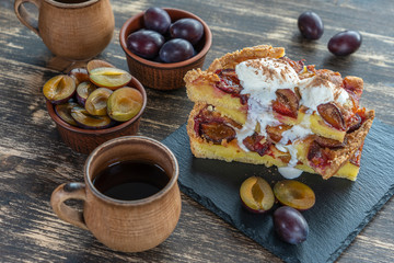 Homemade organic plum pie dessert ready to eat. Plum tart on the old wooden background, close up