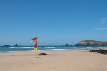 Fototapeta na wymiar lifeguard flags at Constantine Bay Cornwall