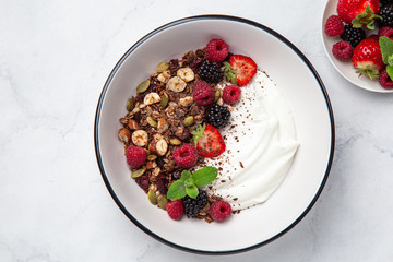 Chocolate  granola with yogurt and fresh berry in white  bowl