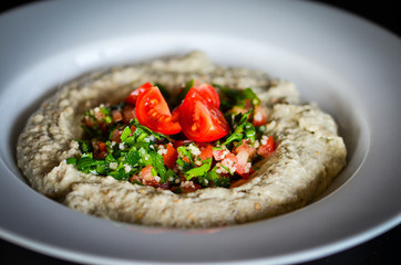 lebanese hummus dish with fresh vegetables, beef meat & pomegranate seeds