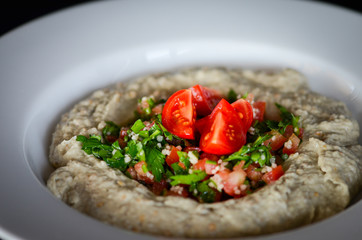 lebanese hummus dish with fresh vegetables, beef meat & pomegranate seeds