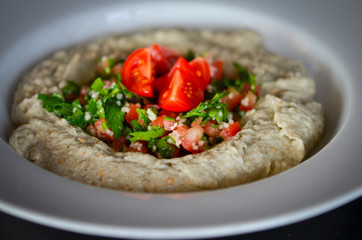 lebanese hummus dish with fresh vegetables, beef meat & pomegranate seeds