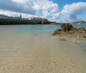 view of the historic old town of Saint-Malo with beach and coast at low tide