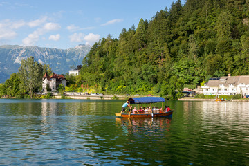 Fototapeta na wymiar Pleasure boats with tourists on Lake Bled in Slovenia.