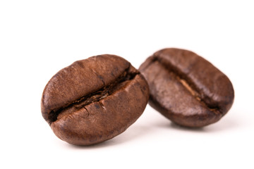 two coffee beans on a white isolated background close-up