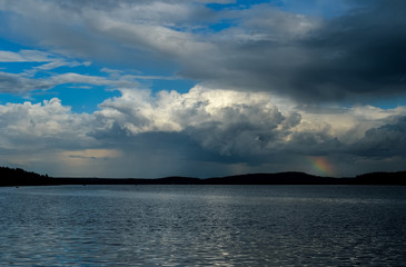 Obraz premium clouds and rainbow on the sea