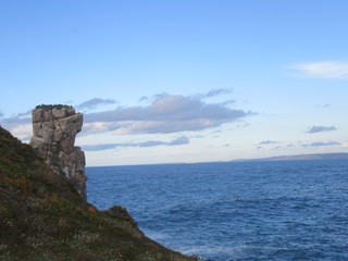 clifs by the ocean with skyline and clouds in peniche, portugal