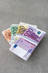 Euro currency money. Cash money, euro bills. Stacks of Euro notes on concrete background in five hundred, two hundreds, one hundreds and fifties. Copyspace for text