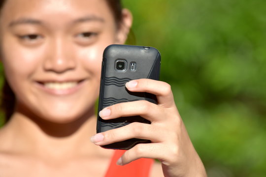 Selfie Of Pretty Filipina Youth With Cellular Phone