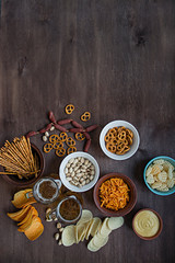 Beer snacks. Chips, nuts, pistachios for beer. Wood background. View from above. Place for text.