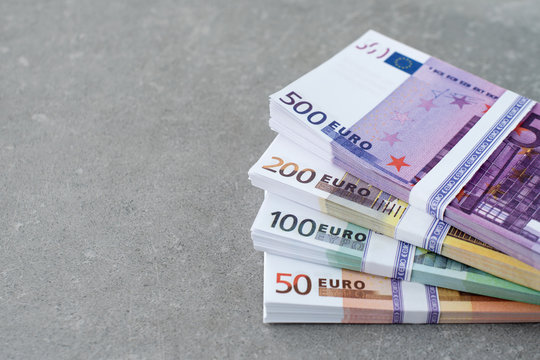 Euro currency money. Cash money, euro bills. Stacks of Euro notes on concrete background in five hundred, two hundreds, one hundreds and fifties. Copyspace for text