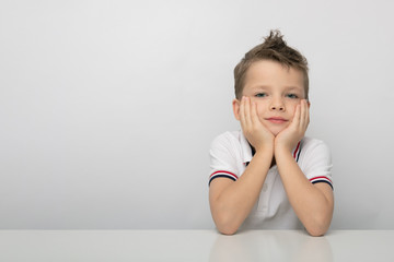 Smiling boy close-up on gray background. Isolated