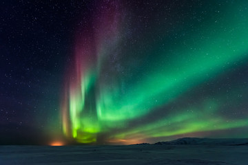 Northern lights aurora borealis in the winter  - obrazy, fototapety, plakaty