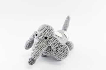 Gray dog (dachshund), knitted toy. Isolated on white background