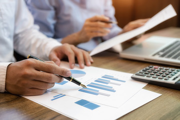 Fototapeta premium Business team brainstorming and discussing with financial data and report graph. Teamwork meeting working concept.