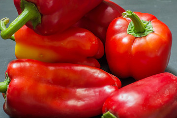 Red sweet pepper close-up on a black table.