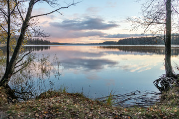 Lake (Lielezers) view with sunset sky and reflections in autumn in Latvia