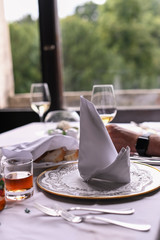 Glass of wine on the table by the window. Interior of a classic restaurant in an old castle. Traveling in Europe. Served tables and antiquity.