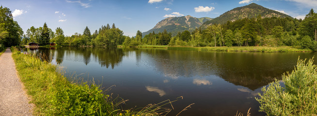 High resolution stitched panorama of a beautiful alpine view with a lake with mountain reflections at Oberstdorf, Bavaria, Germany