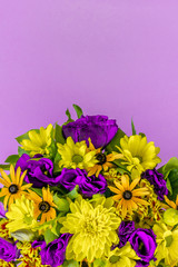 close - up of colorful beautiful spring bouquet isolated on lilac background. Bright fresh purple and yellow flowers. Decorative composition greeting card for the holiday on the birthday. Copy space