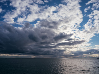 Rain on sea and dark storm clouds rain.