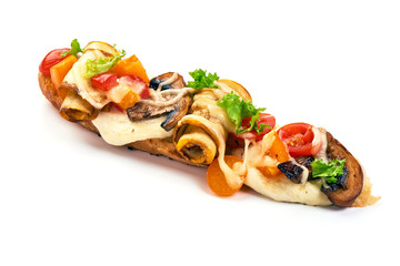 Spanish Tapas and Pinchos with champignon mushrooms, tomatoes, soft cheese slices and herbs, isolated on white background