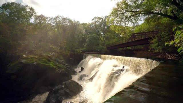 Time Lapse of a Gorgeous Waterfall Scene in the Forest with Mist Lifting into the Light, Steady Shot