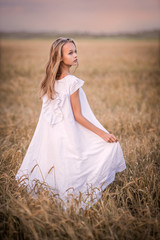 Fototapeta na wymiar Portrait of a teenage girl in a wheat field