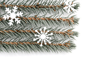 Naklejka na ściany i meble Sprigs of blue spruce with snowflakes are arranged horizontally in even rows on a white background. Christmas, new year concept, texture.