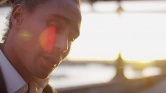 Casual professional in the city is worried and thinking to himself, in slow motion 