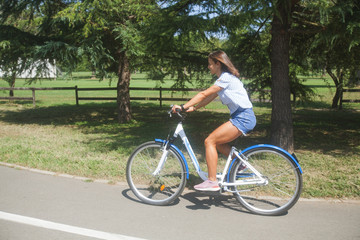  Young Woman Riding Bicycle In The Park