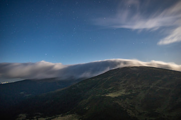 Fototapeta na wymiar Panorama of the starry sky over the foggy mountains