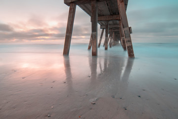 Long Exposure of the shore beneath Johnnie Mercers Fishing Pier before sunrise. Wrightsville Beach, North Carolina