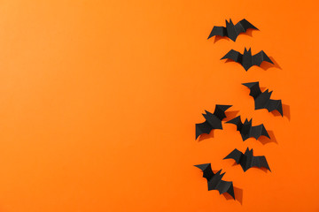 Decorative bats on orange background, space for text