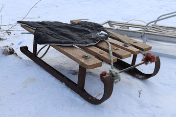 Vintage Ukrainian sled from iron and wood on the snow. Winter rest. Having fun outdoors.