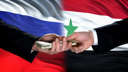 Russia and Syria officials exchanging money, flag background, business agreement