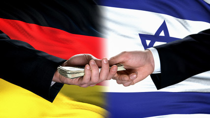 Germany and Israel officials exchanging money, flag background, business deal