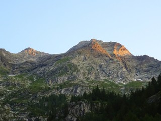 The "Monte Rosa", and the mountains of the Anzasca valley during sunrise on a summer day near the town of Macugnaga, Italy - August 2019.