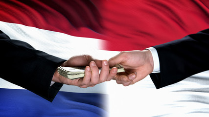 Netherlands and Indonesia officials exchanging money, flag background, deal