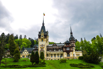 Obraz premium Sinaia, Romania, May 15, 2019: Panorama of the Peles Castle, a Neo-Renaissance castle in the Carpathian Mountains.