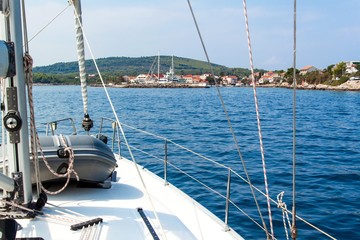 Fototapeta na wymiar Port of Sucuraj on island Hvar, Croatia, view from yacht. Holiday in Croatia. Ship transportation. Yachting sport.
