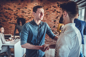 Fototapeta premium two businessmen shaking hands in office