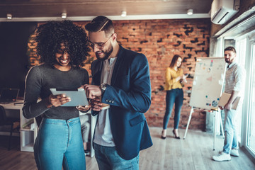 Young woman use tablet for consulting with her boss about the needs of the client in the design.