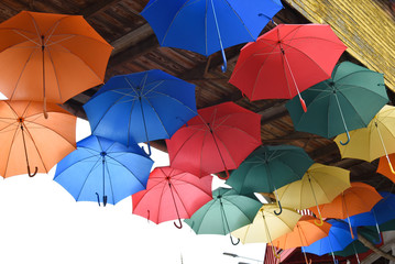 Fototapeta na wymiar Many bright multicolored umbrellas under ceiling. fun, revelry.