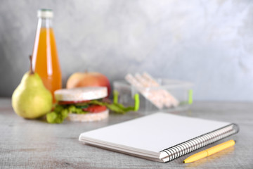 lunch for your child in school, box with a healthy sandwich and fruit salad and apple juice in the bottle for drinking
